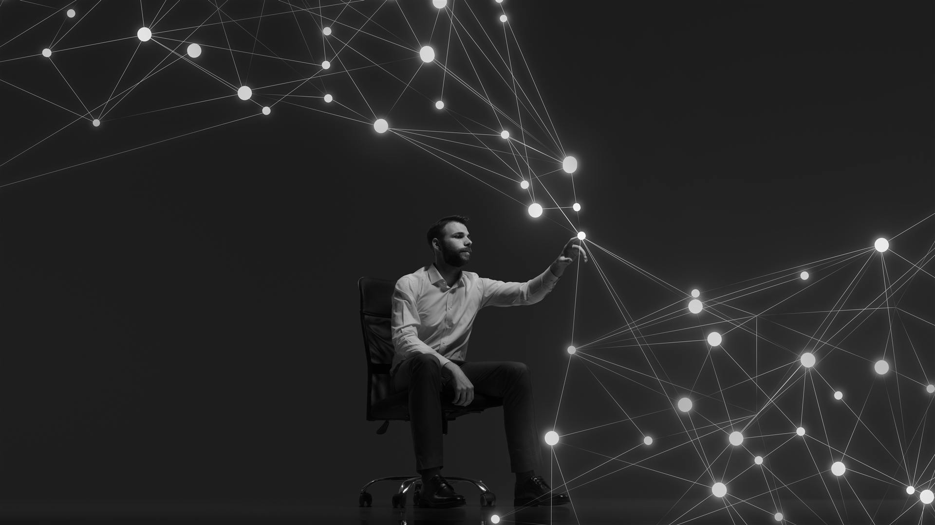 A person reaching out to touch a constellation of connected points of light